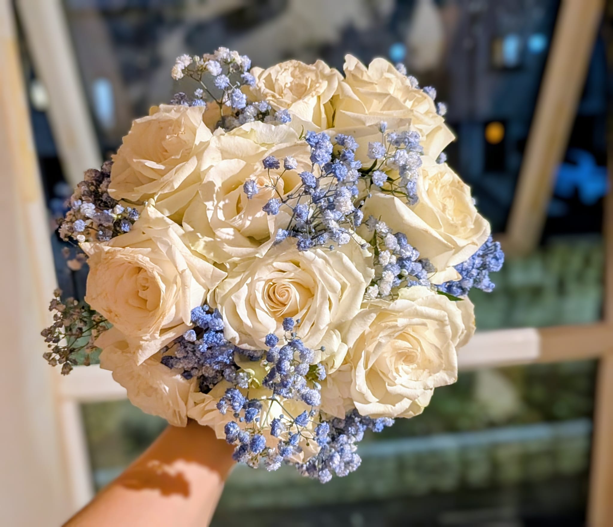 Top-down view of a blue and white bridal bouquet showing clustered blooms