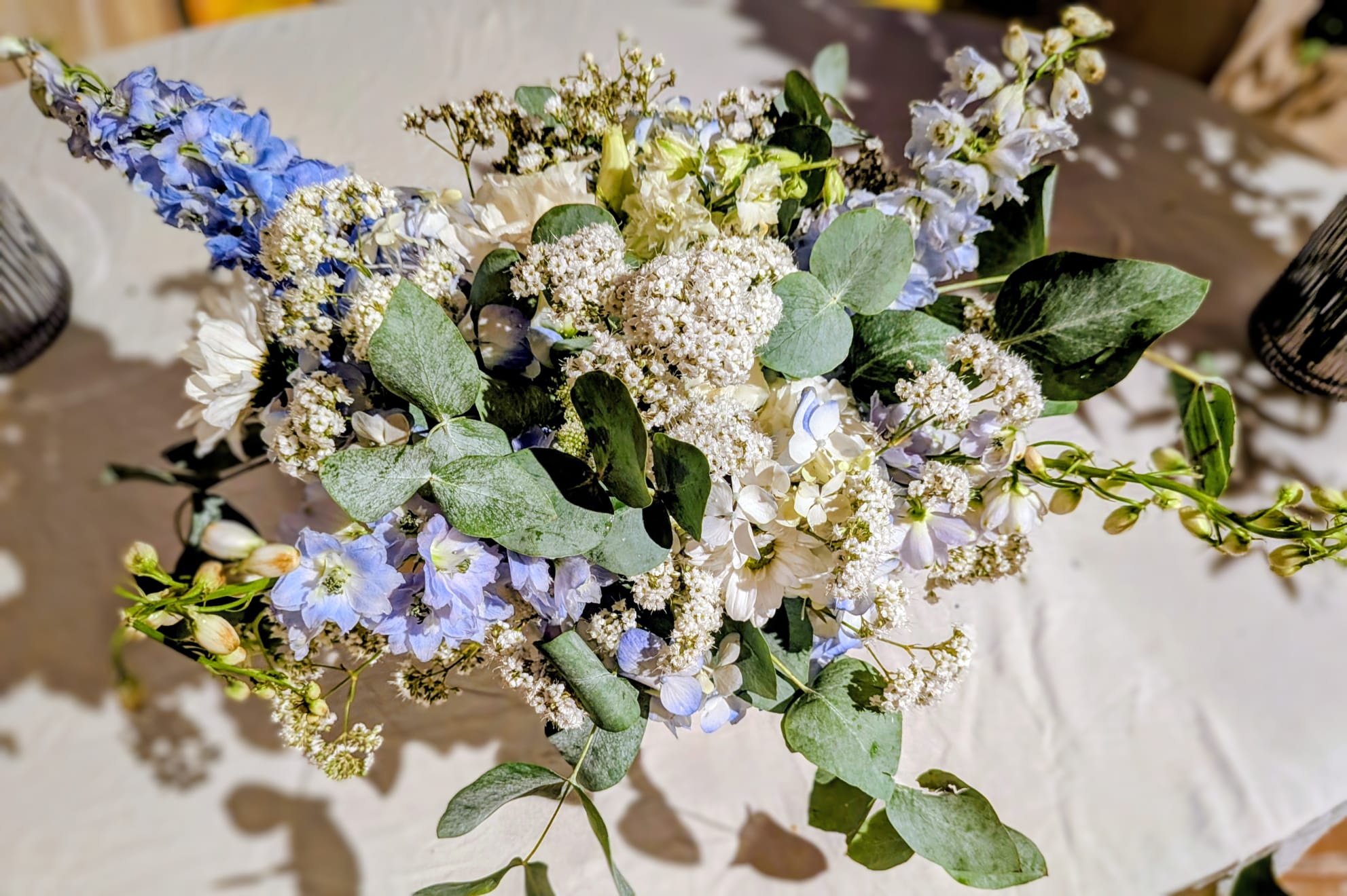 Top view of a blue and white wedding table centrepiece with candles
