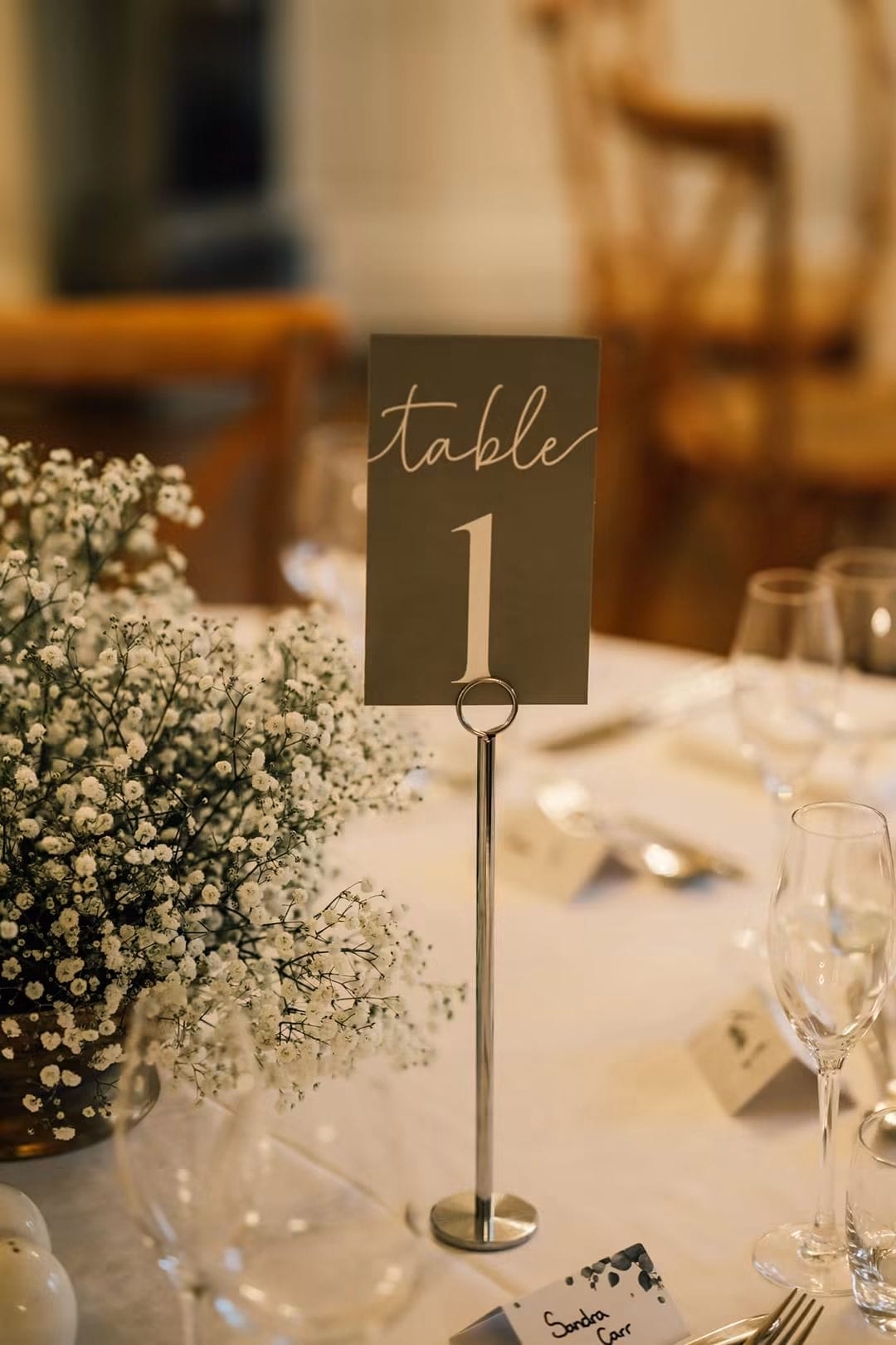 Wedding reception table with floral centrepiece and candle styling